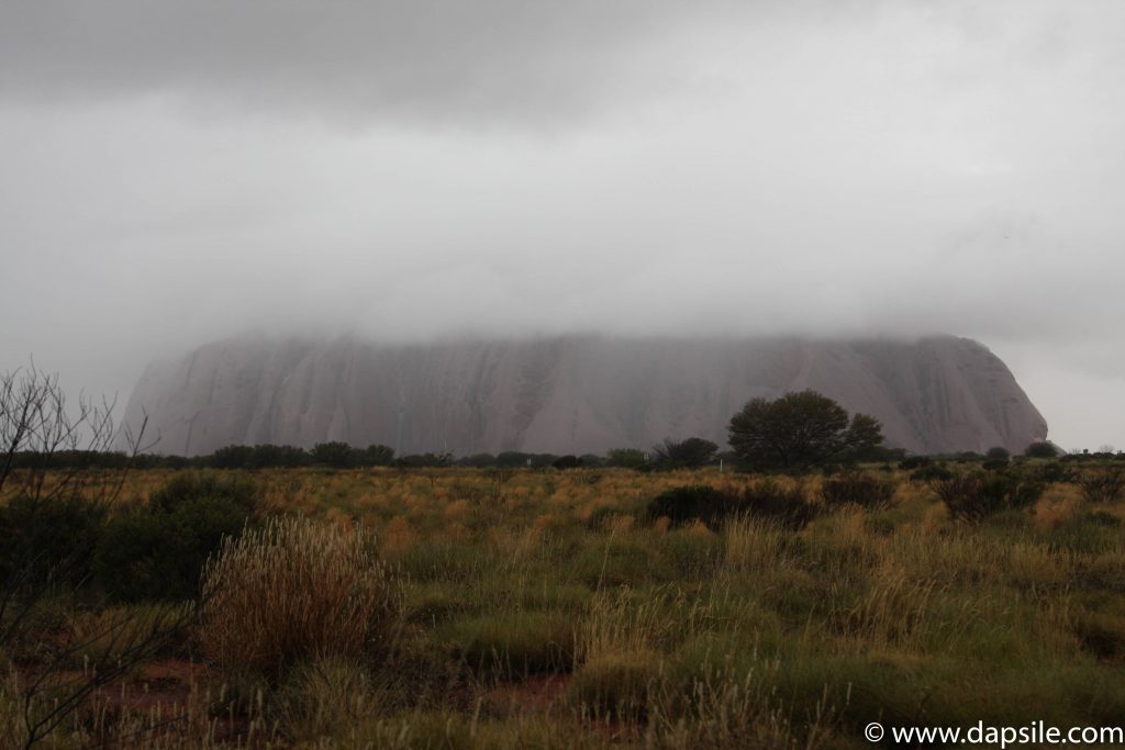 Uluru being devoured by Clouds from a tour from Alice Springs to Uluru