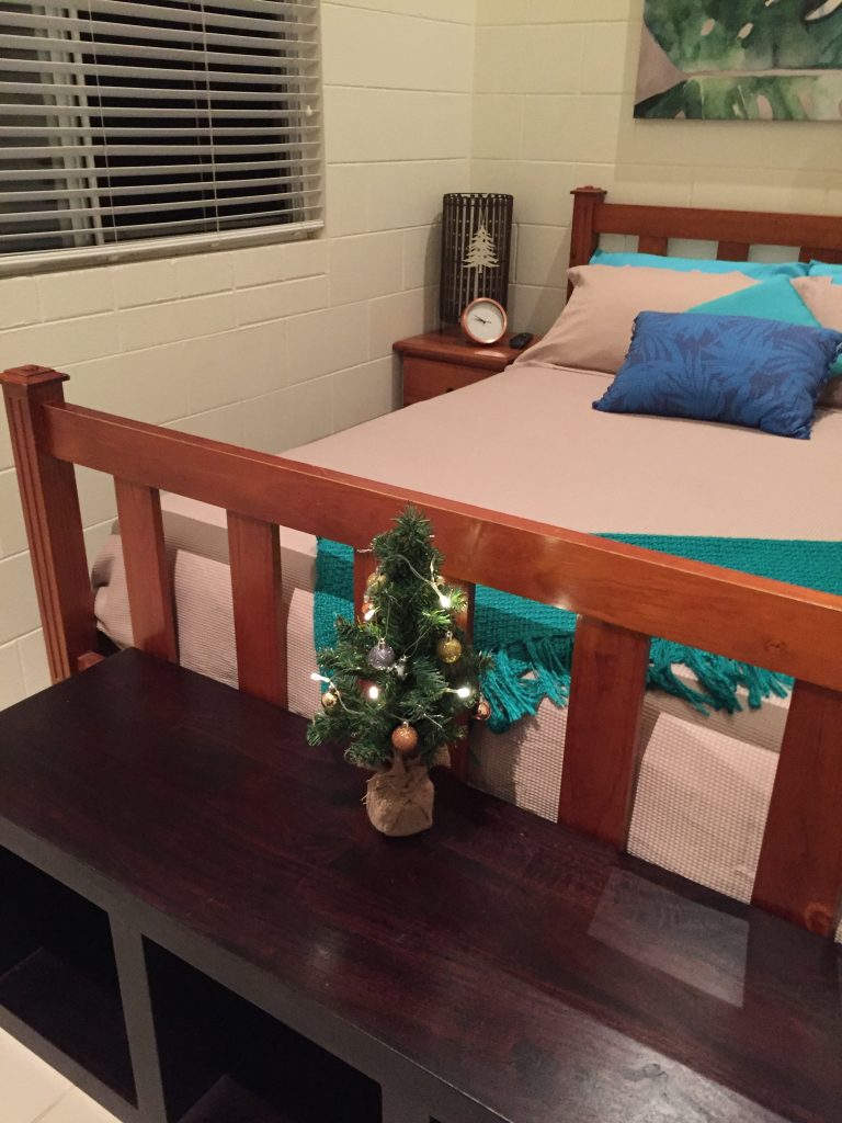 Bed and mini Christmas tree in the Airbnb room in Cairns