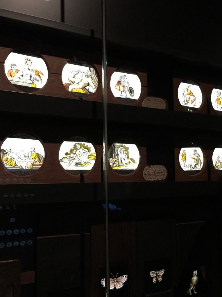 Eearly hand painted on glass picture slides in a glass case at the Rijksmuseum in Amsterdam