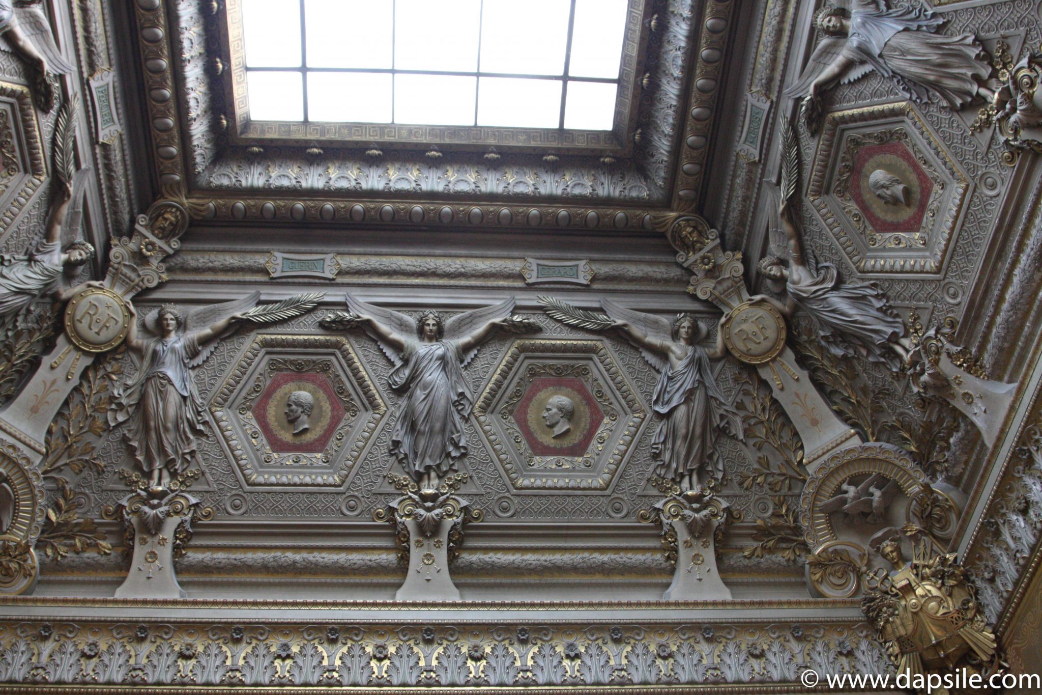 A Decorative Ceiling with a Window in the Louvre in Paris