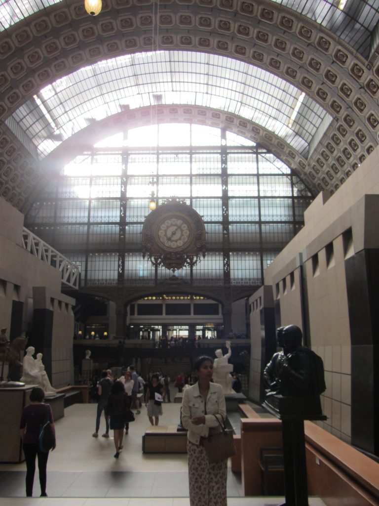Looking at the Wall of Windows and the Big Clock in the Main Hall of the Musee d'Orsay in Paris