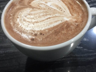 Waves Hot Chocolate Waves Hot Chocolate in a mug with a heart pattern in the milk