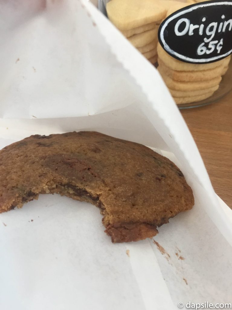 Half Baked Cookie Company Chocolate Chip Cookie from the top with a bite out of it