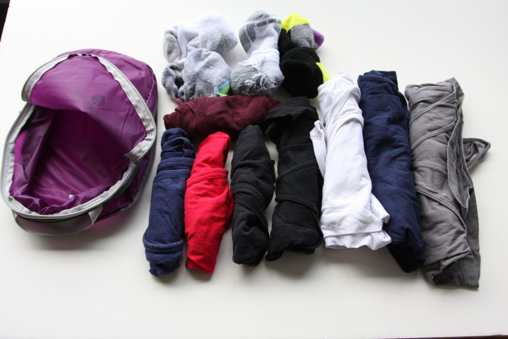 open Eagle Creek small Compression Bags with four pairs of socks, four pairs of underwear, and four tank tops