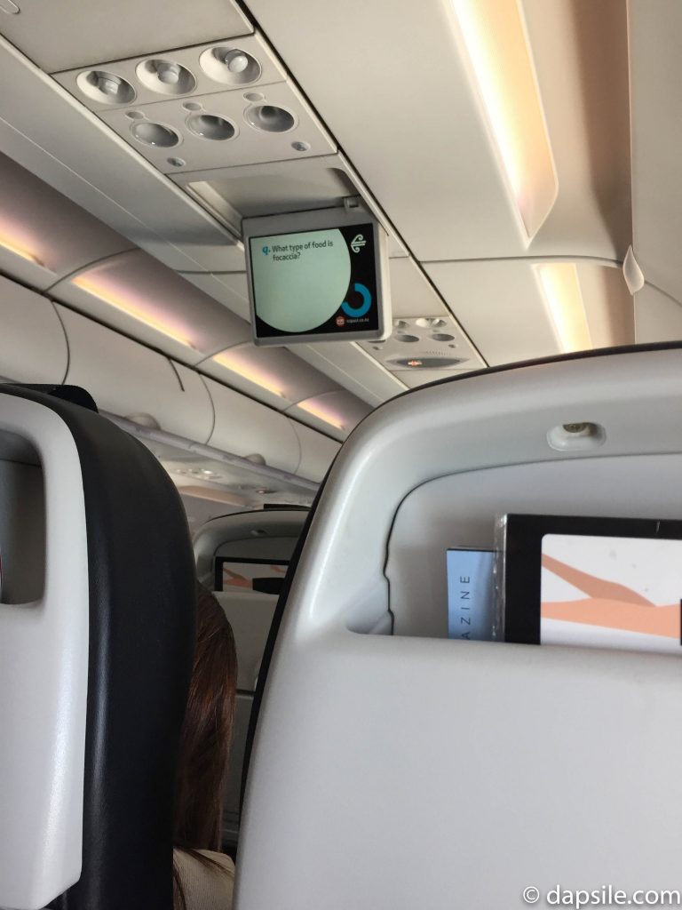 Screen hanging from the ceiling Inside Air New Zealand Airplane