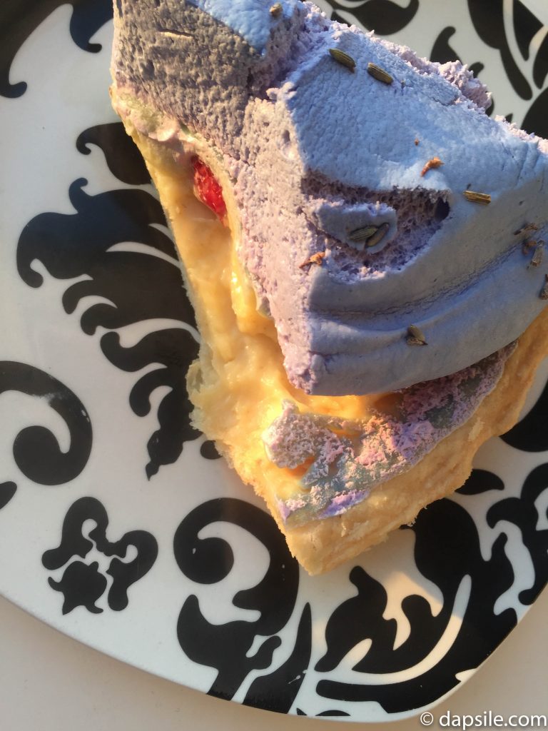 Tartine Bread and Pie Shop&#039;s Lavender Raspberry Pie viewed from top on a black and white plate